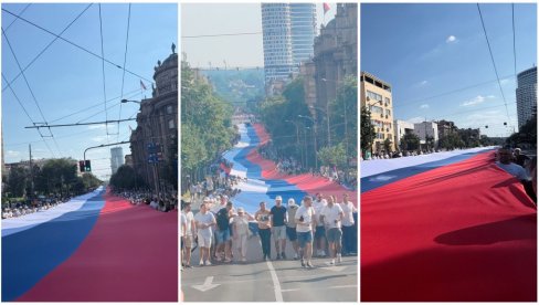 ПРИЗОР ОДУЗИМА ДАХ, НЕМОГУЋЕ ЈУ ЈЕ ЦЕЛУ СНИМИТИ: Српску тробојку носи 2.500 људи, дугачка је 500 метара, а тешка око тону (ФОТО/ВИДЕО)